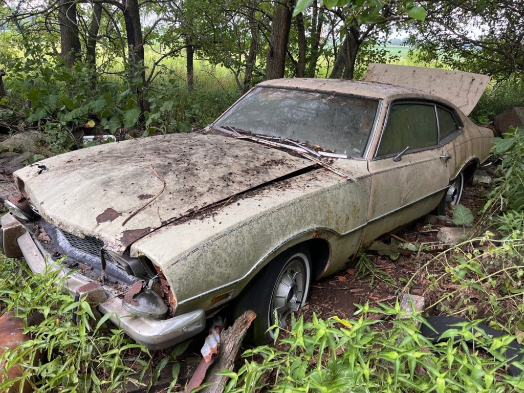 this 1973 ford was forgotten in a barn that fell apart now abandoned in the woods 194808 1 1024x768 1