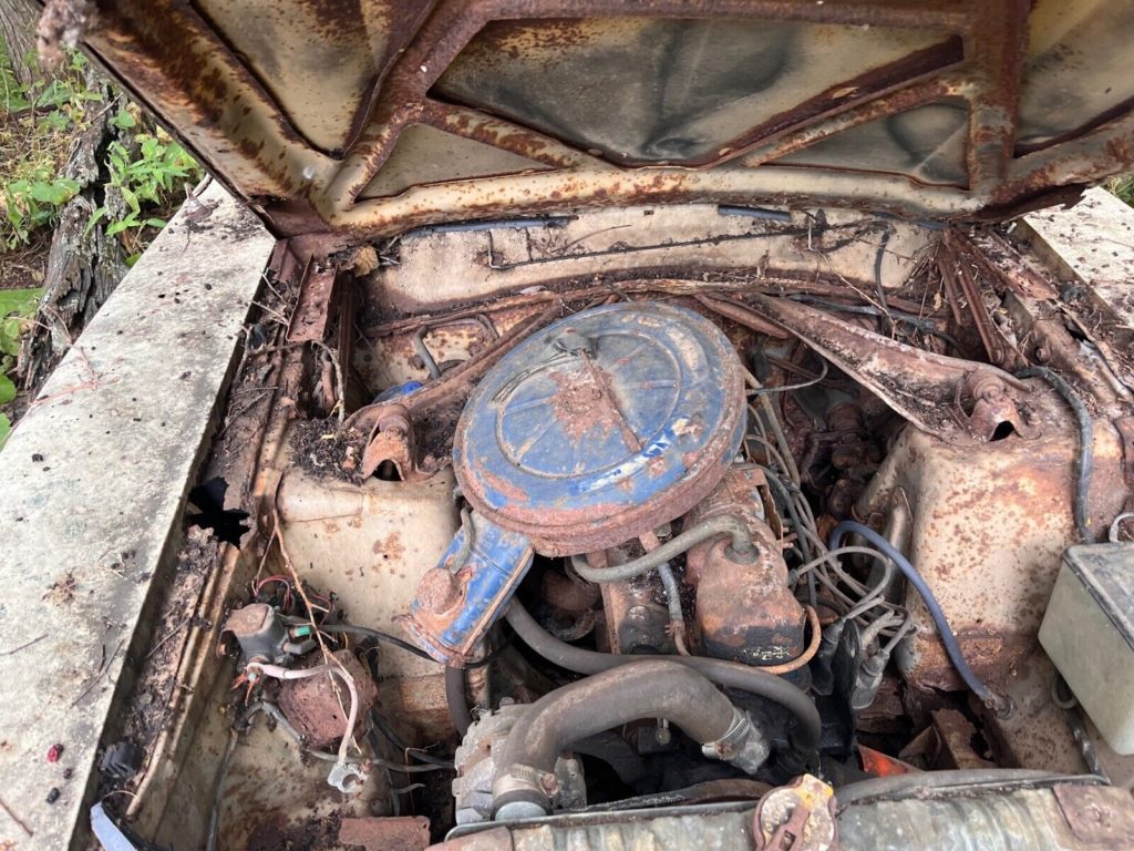 this 1973 ford was forgotten in a barn that fell apart now abandoned in the woods 14 1024x768 1