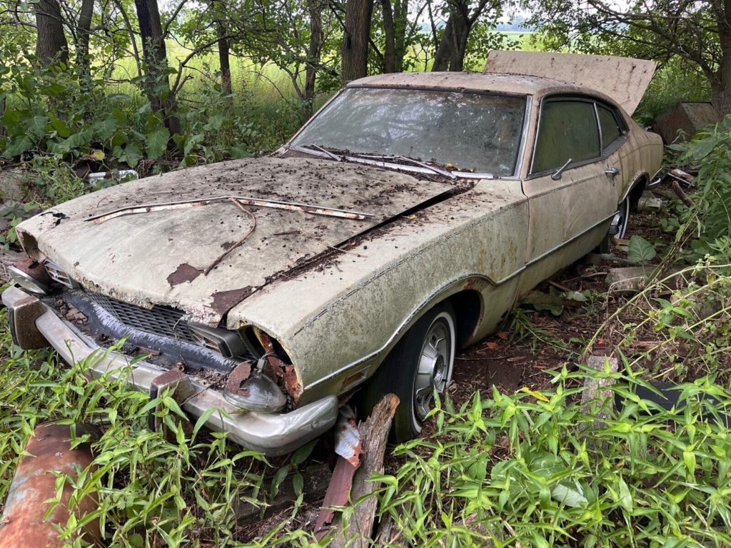 this 1973 ford was forgotten in a barn that fell apart now abandoned in the woods 18 1024x768 1